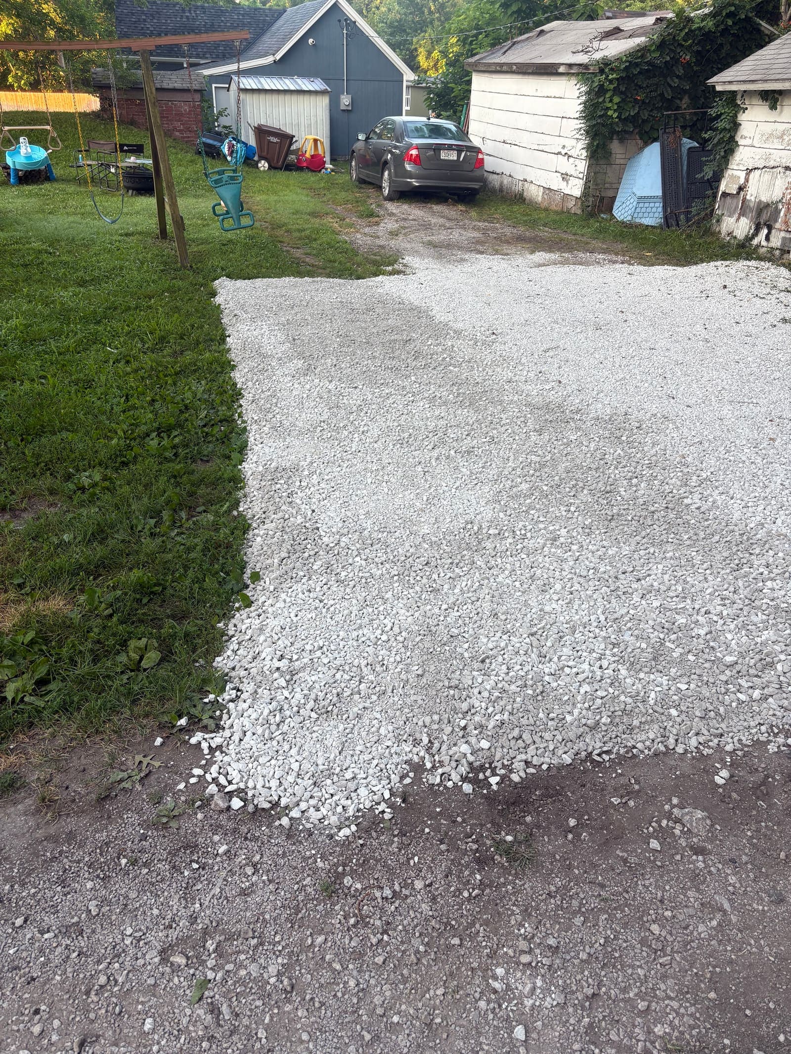 Fresh white limestone gravel spread on a residential driveway